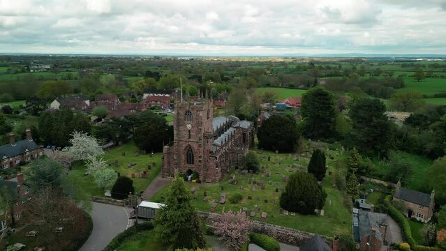 St Boniface, Bunbury, Cheshire - a quintessential English village Church - Aerial drone clockwise fast pan, May 23