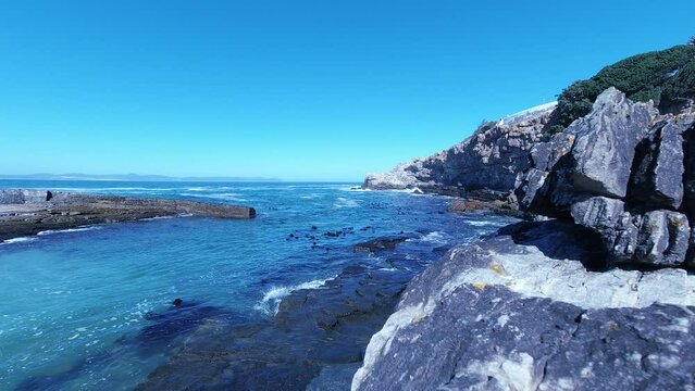 Timelapse of small rocky natural harbour, with waves coming in and out.