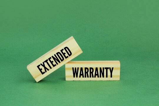 wood with the word Extended Warranty. the concept of warranty extension or warranty addition