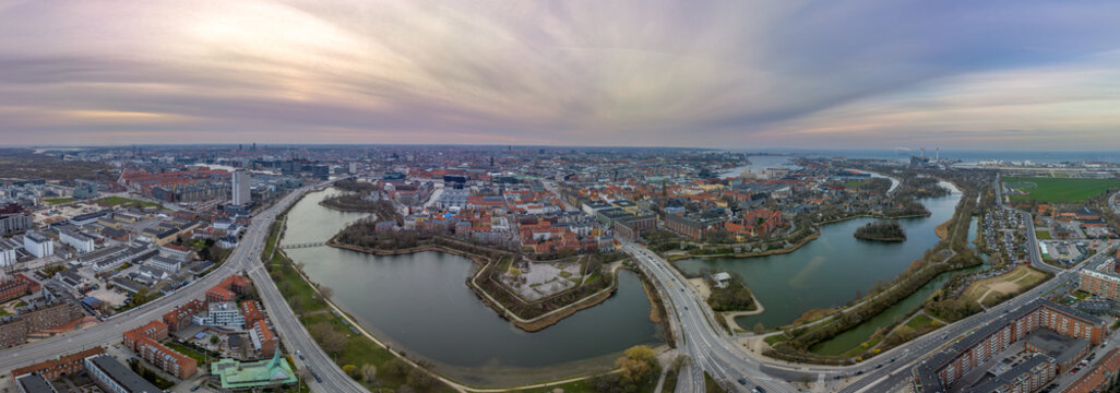 Aerial view of polygonal bastions and water filled moat protecting Copenhagen Christiania neighborhood during sunset