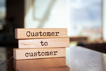 Wooden blocks with words 'Customer to customer'.