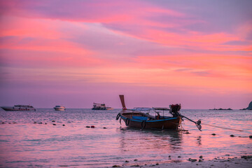 KOH LIPE, Tourist longtail boat at pattaya beach with beautiful colorful sunset sky in twilight time. Summer or Travel concept. - obrazy, fototapety, plakaty