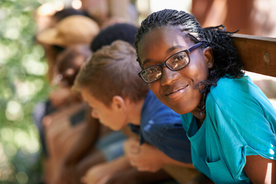 Black girl, camp or friends portrait with happiness or glasses outdoor. Happy, African and female teen with face and a smile from summer camping, holiday or team building with fun people in treehouse