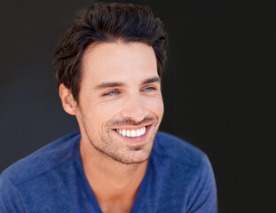 Face, smile and handsome man or happy male with white teeth or oral hygiene and isolated on a dark,...
