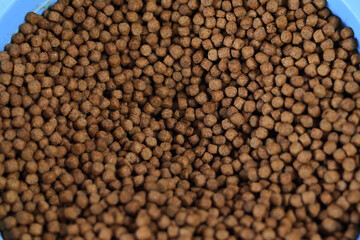 Animal feed for all kinds of fish closeup on white background. Feed for catfish