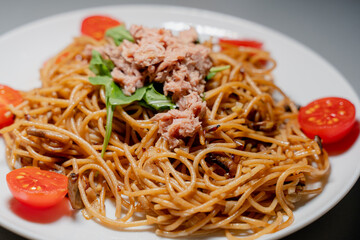 Cooking. Spaghetti with tuna and tomatoes.