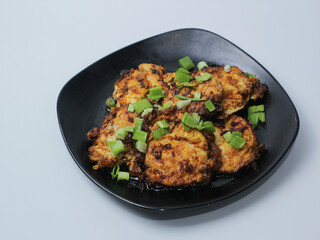 Balado eggs with a sprinkling of green onions. Spicy and savory. Warteg menu.