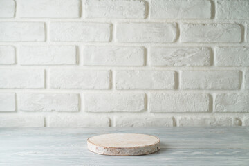 Empty wooden podium on table over white brick wall  background. Interior for mock up design and...