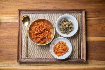 Korean food side dishes, Stir-fried Squid and Vegetables,Stir-fried Anchovies with Nuts and Sesame Leaf with aged Korean soy sauce and rich seasoning Korean traditional food.