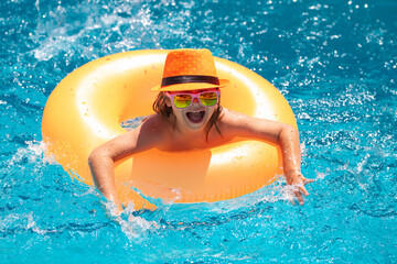Kid in swimming pool. Child summer vacation concept. Summer kids portrait in sea water. Funny kids summer face.