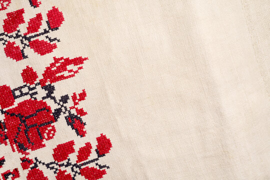 Fototapeta Embroidered good like old handmade cross-stitch ethnic Ukraine pattern. Ukrainian rushnyk . Red version over white background. Beige white farmhouse style stripes texture. Woven linen