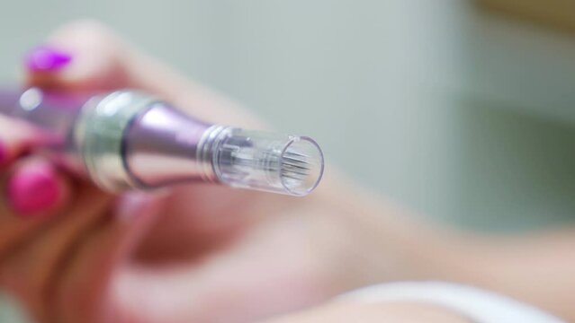 Dermapen with microneedles used for facial treatments. Close up.