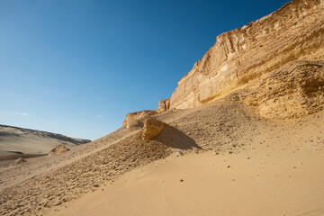 Barren desert landscape in hot climate with mountain rock formation