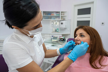 beautiful young patient came to a female dentist for caries treatment.