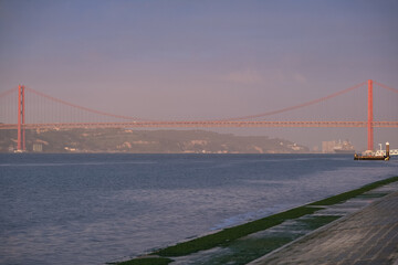 Luxury ocean liner cruiseship cruise ship Victoria or Elizabeth in port of Lisbon, Portugal during Mediterranean cruising with city skyline, Christos statue and suspension bridge