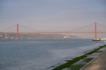 Luxury ocean liner cruiseship cruise ship Victoria or Elizabeth in port of Lisbon, Portugal during Mediterranean cruising with city skyline, Christos statue and suspension bridge