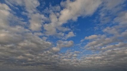 Obraz premium pretty yellow, blue and orange light sundown clouds cloudscape - photo of nature