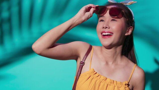 ready to fight the sun,confident asia woman wear summer dress cloth and sun glasses hand protect sunlight smiling delightful cheerful face expression,casual relax woman travel ready to go out