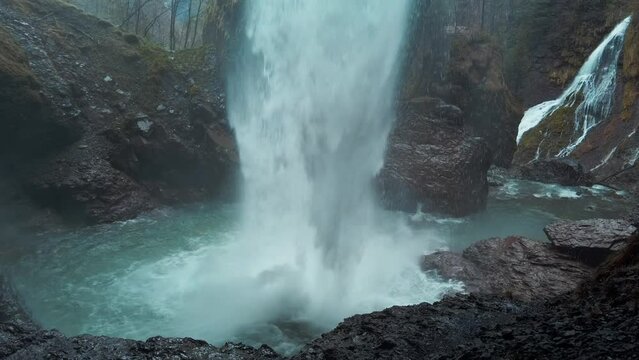 Powerful Berglist&uuml;ber waterfall in Switzerland seen from behind.