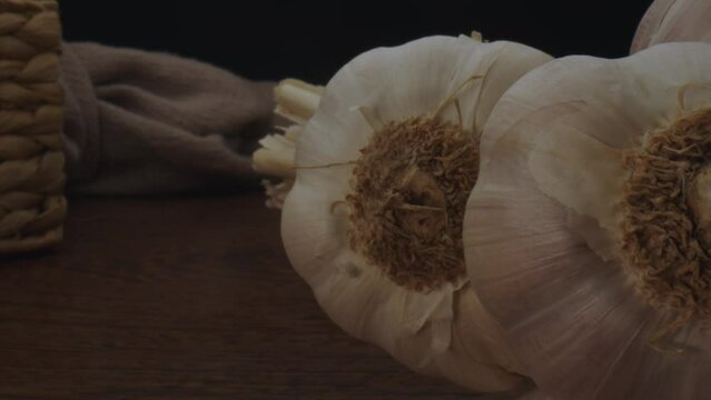 Fresh garlics on table, dolly backward probe lens macro view