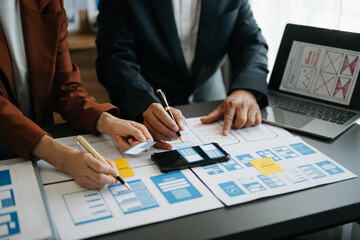  UX developer and ui designer brainstorming about mobile app interface wireframe design with...