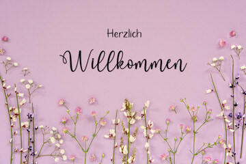 Purple Spring Flower Arrangement, German Text Herzlich Willkommen Means Welcome