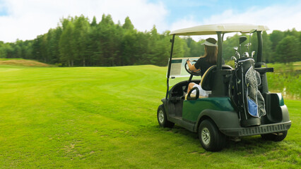 Young woman golfer driving a golf cart
