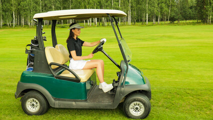Young woman golfer driving a golf cart