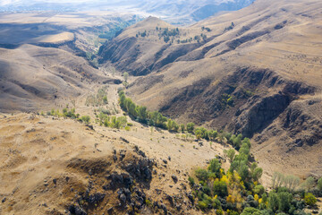 Aerial view of Armenian semiarid landscape nearby Carahunge (Zorats Karer) prehistoric archaeological site on sunny autumn day. Sisian, Syunik Province, Armenia.