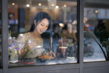 Woman enjoy her breakfast in coffee shop