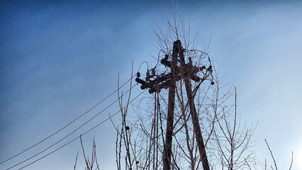 Power electric pole with line wire on blue background close up, photography consisting of power...