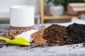 Ingredients for the soil of home potted plants, peat, earth, sand, perlite, vermiculite, coconut. A mixture for planting plants in a pot. Layout