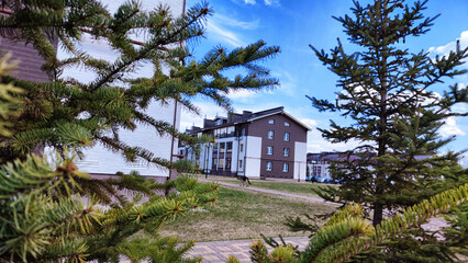 New house on the street in small village or town in a spring or atutumn day. Landscape with...