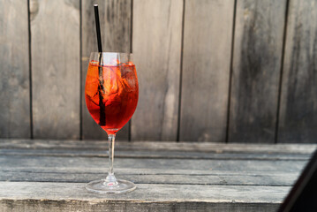 Still life of aperol spritz cocktail on wooden surface