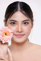 Obraz na płótnie Canvas Beautiful make up Asian woman with perfect clear and fresh skin holding flower isolated over white background. Cosmetology, beauty and spa, wellness, Plastic surgery.