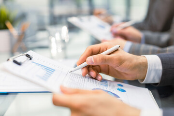 Business adviser analyzing financial figures denoting the progress in the work of the company.