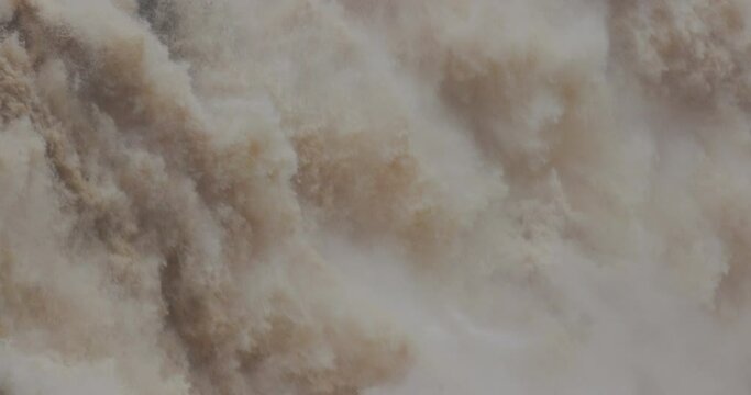 Close up water rushing down waterfall at Barron Falls in Cairns, Australia.