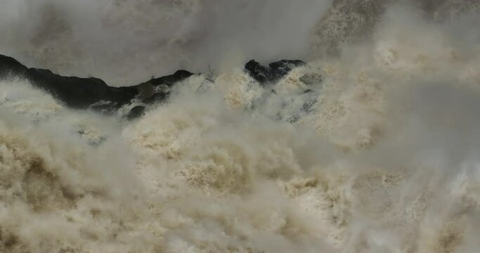 Close up of water rushing down Barron Falls Waterfall in Far North Queensland during wet season.