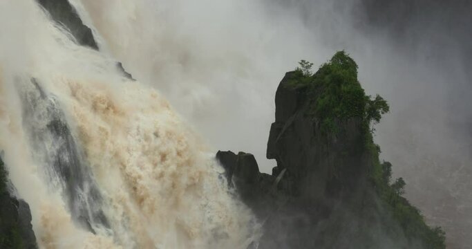 Static footage from the lookout at Barron Falls Waterfall during wet season. Water rushing down rocks.