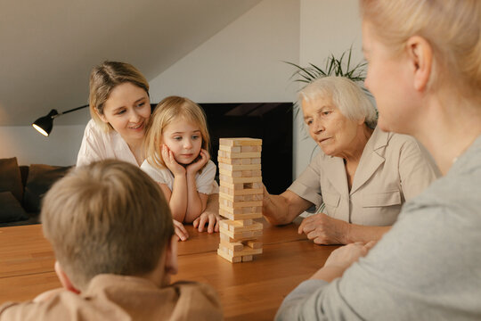 Great grandmother playing game with family at home