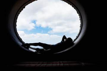 silhouette of a happy child at a round window