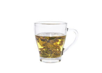 Tea leaves unfolding during the brewing. Green tea in a transparent glass cup.