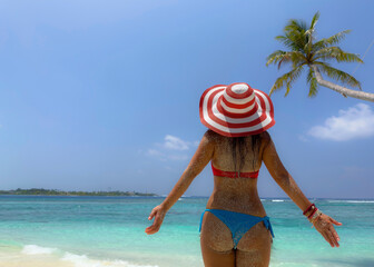 Summer and Relaxing lifestyle young woman lying and sunbathing on the beach
