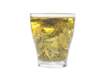 Tea brewing process in transparent glass. Tea leaves unfolding during the brewing.