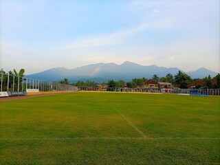 Fototapeta na wymiar Soccer field with mountain backgrounds