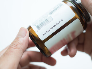 Vitamin Label Expire,Hand Woman holding Drug Medicine Bottle