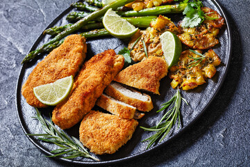 fried chicken breasts with asparagus and potatoes