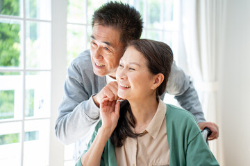 Obraz premium 介護をする男性と車椅子に座る女性