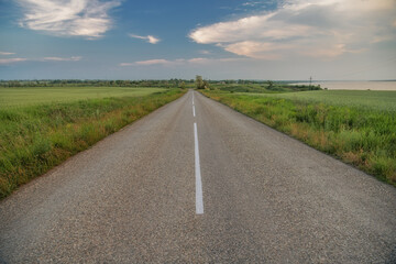 Fototapeta premium The road between the villages, running along the shore of the estuary.