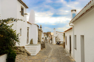 Fototapeta na wymiar Monsaraz town in Portugal by the riverside - a street with white houses